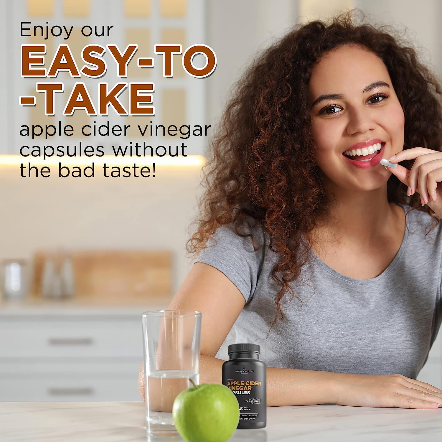 Happy woman taking apple cider vinegar capsule with glass of water and green apple on table.